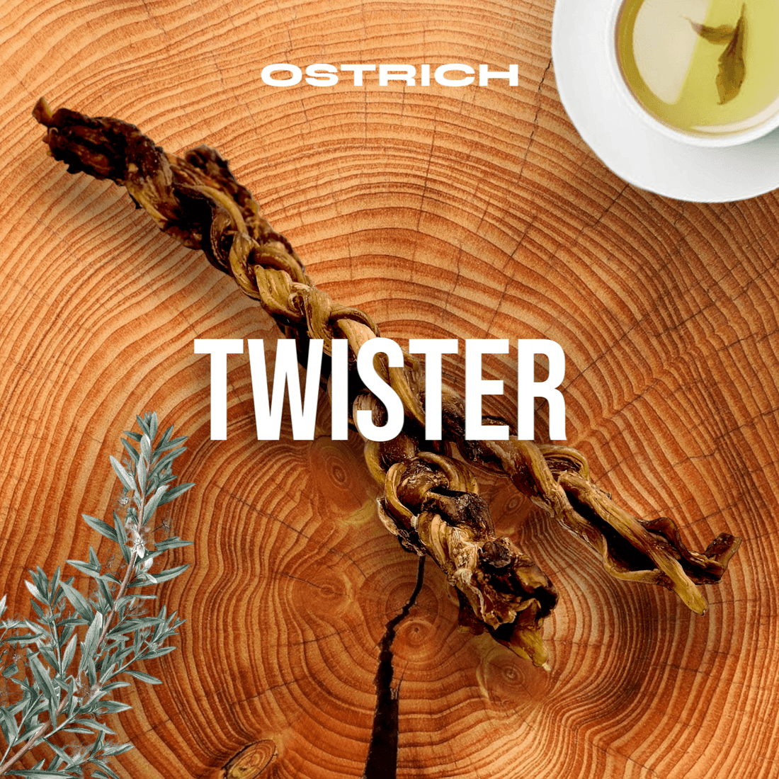Braided snack on wooden surface with tea and plant garnish, labeled 'OSTRICH TWISTER.'